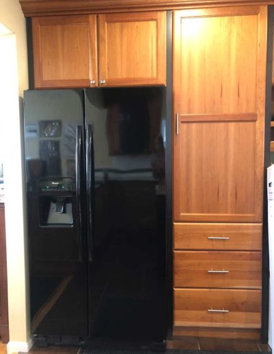 built in kitchen cabinets with a refrigerator